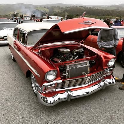 Vintage car with a classic grille and shiny wheels at Pacific Coast Dream Machines event.