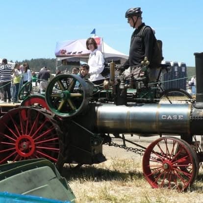 Vintage tractor with a steam engine on display at Pacific Coast Dream Machines in Half Moon Bay, California