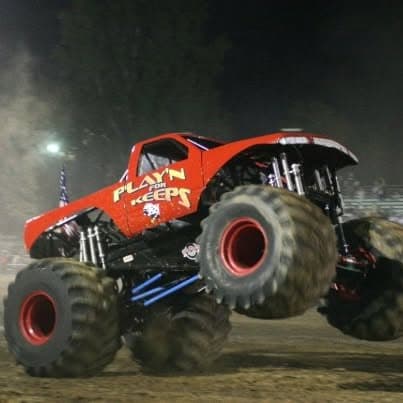 Custom all-terrain monster truck with oversized tires showcased at Pacific Coast Dream Machines event in Half Moon Bay.