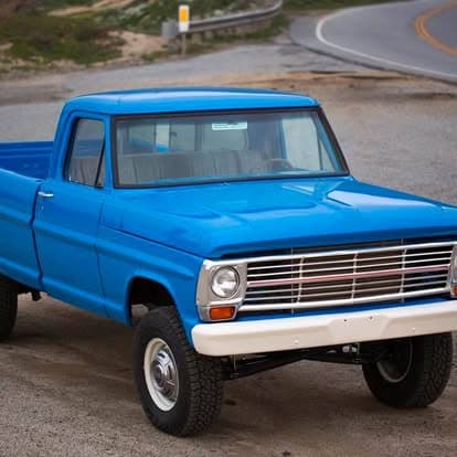 Vintage pickup truck showcased at Pacific Coast Dream Machines in Half Moon Bay, California, featuring a detailed grille and bumper.