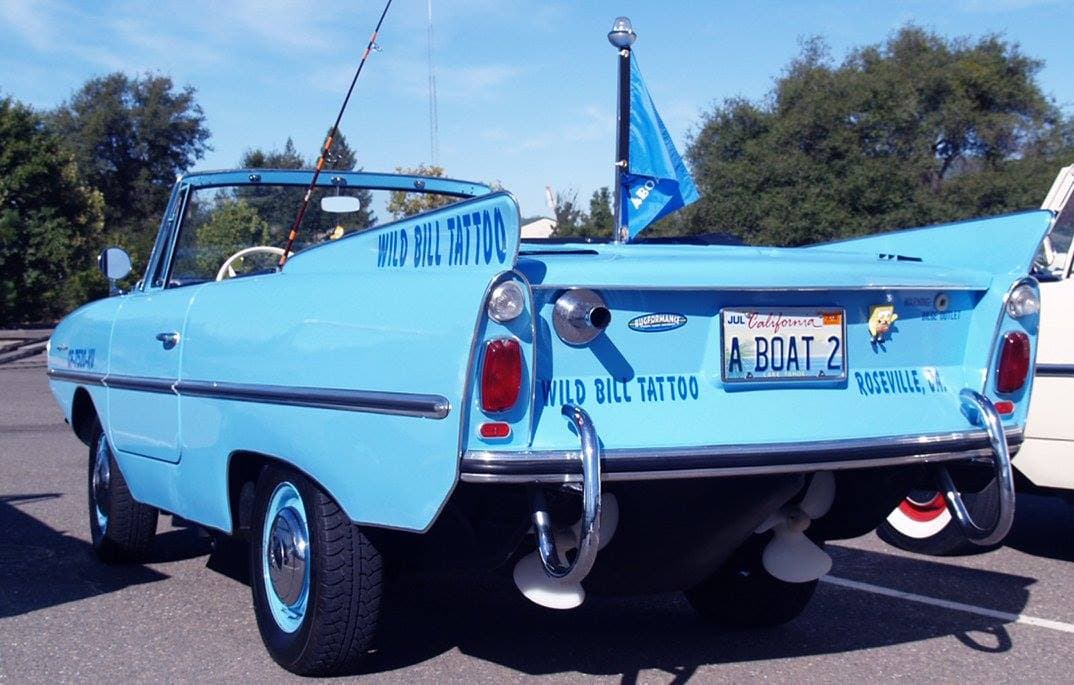 Rear view of Wild Bill's 1964 Amphicar showing 'A BOAT 2' license plate, twin propellers, and Wild Bill Tattoo lettering